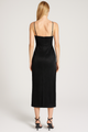 Black dress worn by a model on a white background