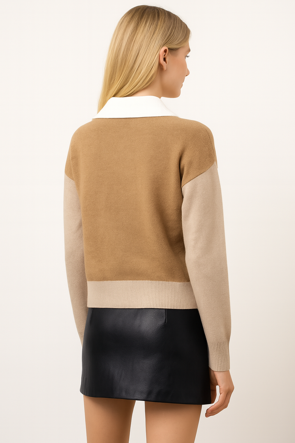 Woman wearing a two-tone sweater with beige and brown colors on a plain background