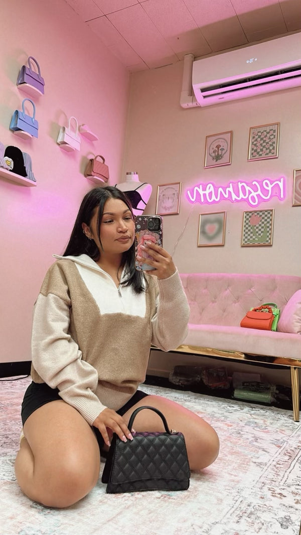 Teresa sitting in front of a mirror taking a selfie