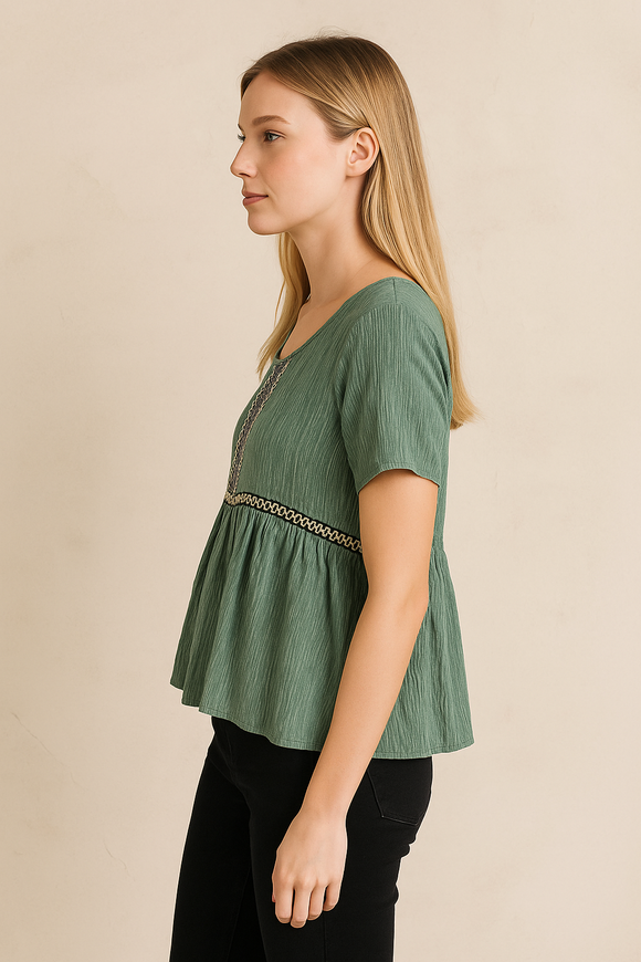 Woman wearing a green blouse with a beige background