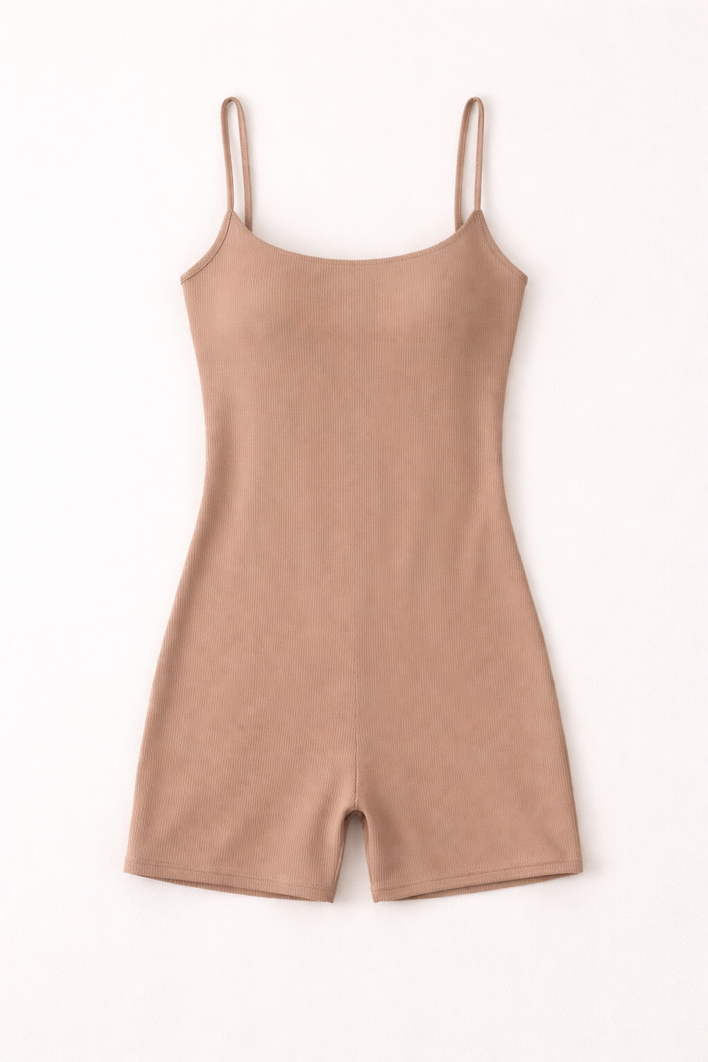 Beige slip dress with thin straps on a white background