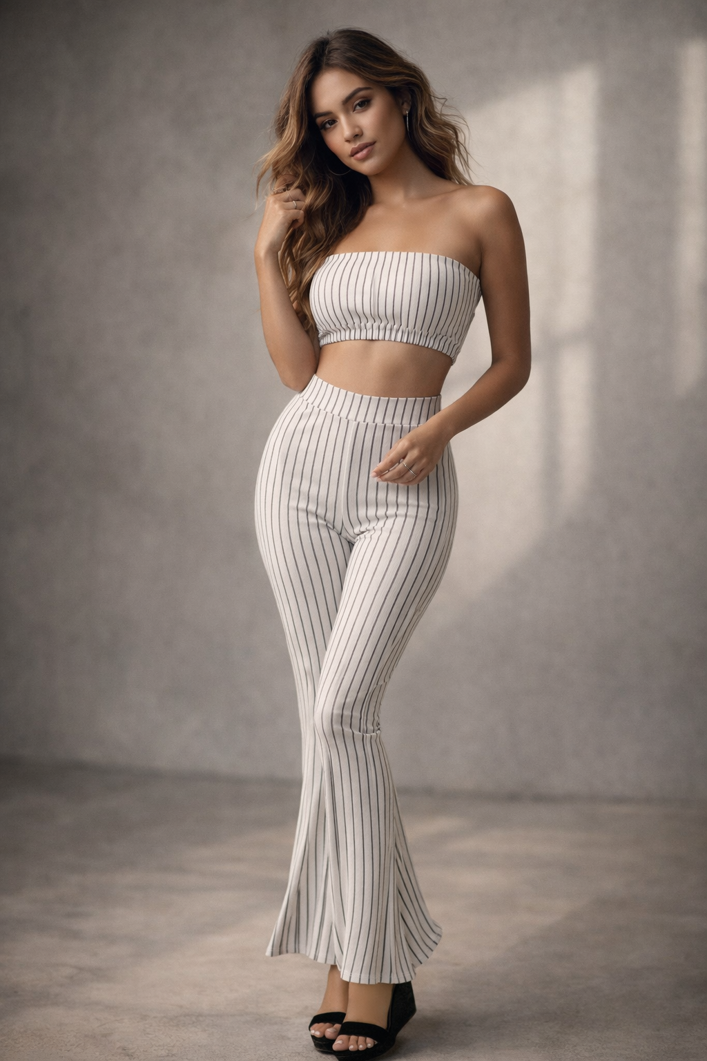 Woman wearing a white pinstripe outfit against a neutral background