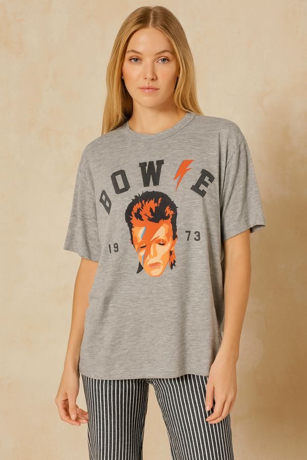 Model wearing gray David Bowie 1973 graphic t-shirt with orange lightning bolt