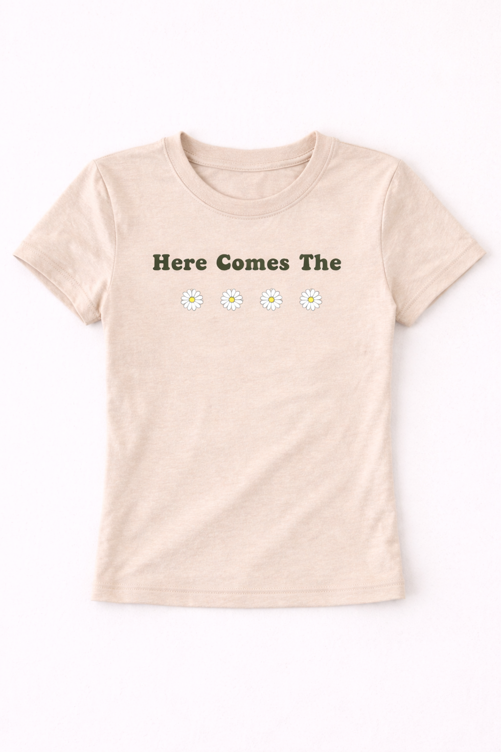Beige t-shirt with 'Here Comes The' text and daisy flowers on a white background