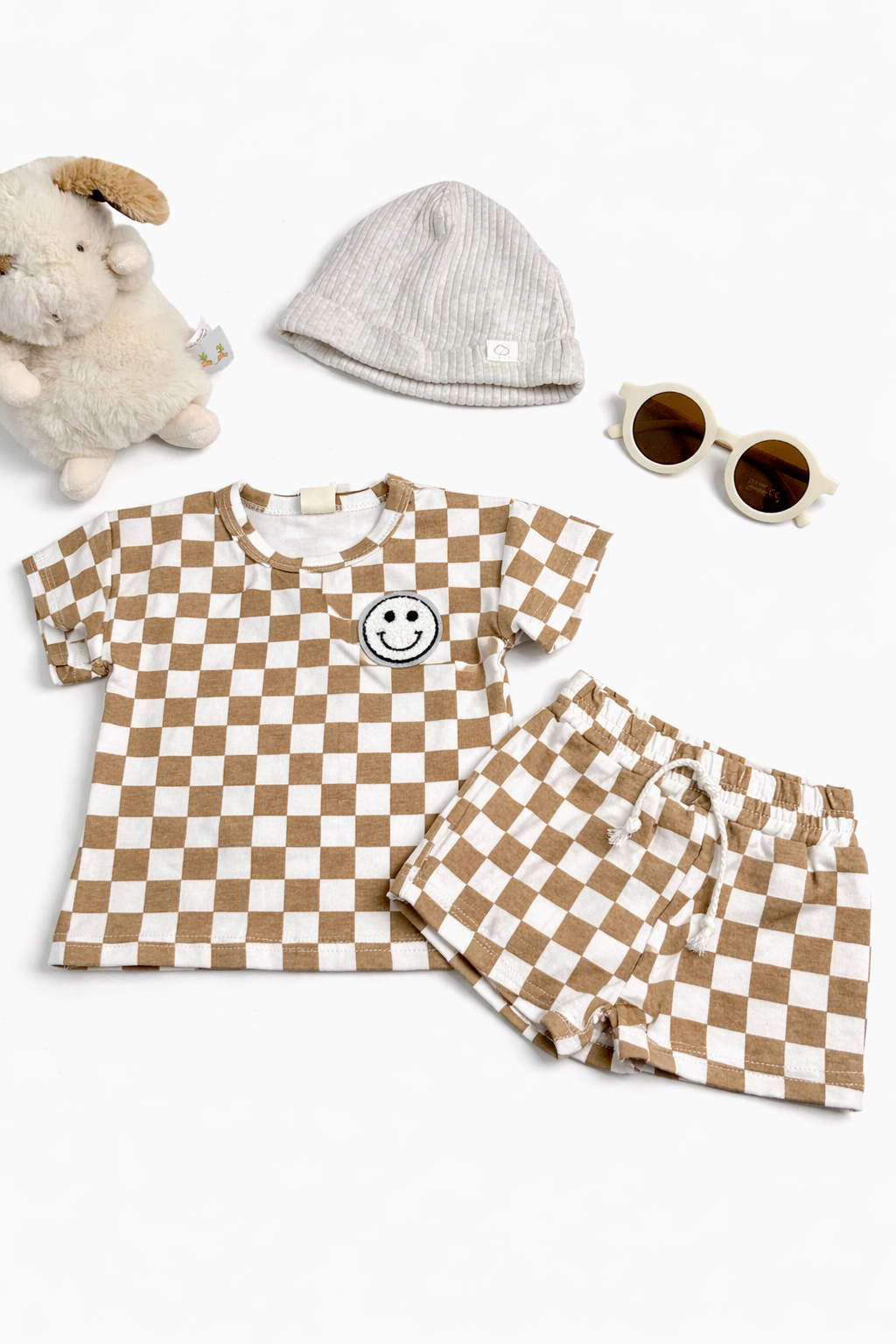 Children's checkered outfit with shirt, shorts, hat, and sunglasses on a white background
