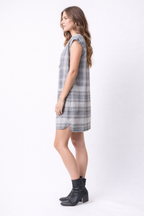 Woman wearing a plaid dress on a white background