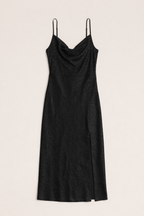 Black slip dress with thin straps on a beige background