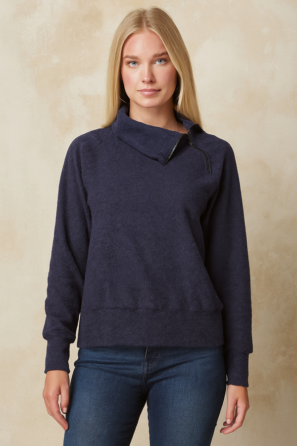Cozy navy cowl-neck sweater styled with black pumps and motorcycle, edgy fashion look