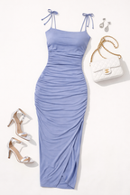 Light blue dress with matching shoes, handbag, and earrings on a white background